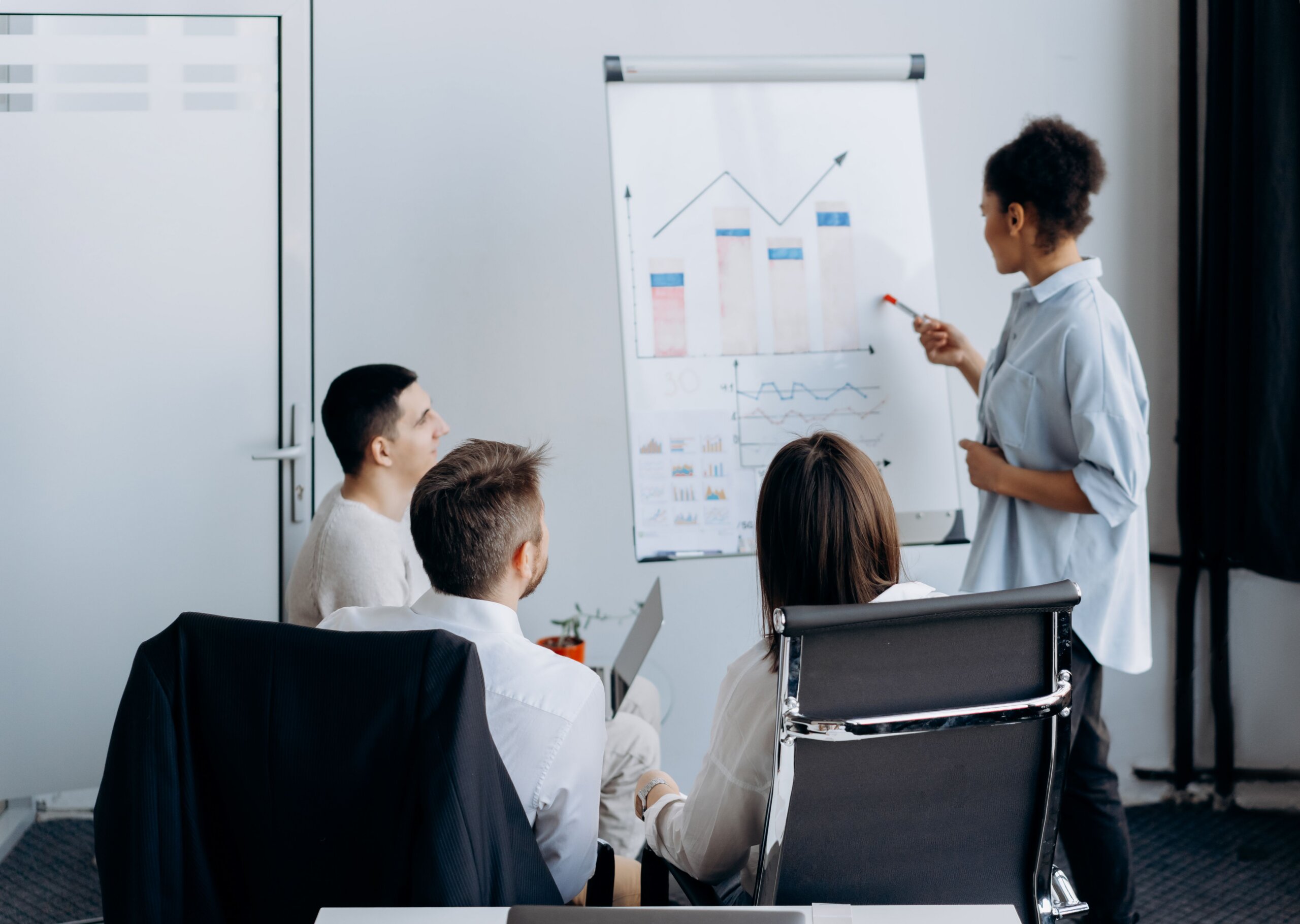 Business professionals collaborating during a leadership meeting, discussing strategies and planning for the future of community association management.